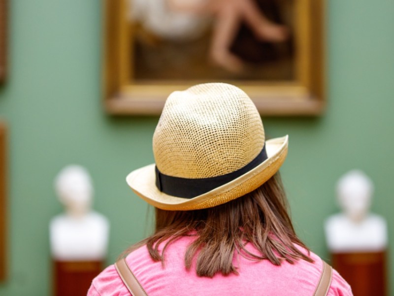 Eine Frau betrachtet Bilder im Museum.